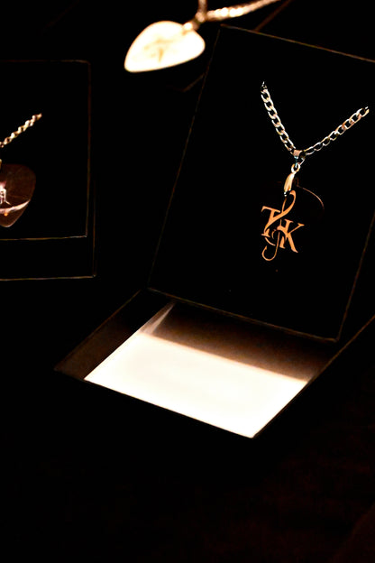 Gold necklace with a pendant in a black jewelry box