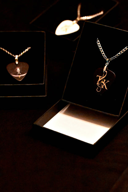 Heart-shaped pendant necklace on display with a dark background