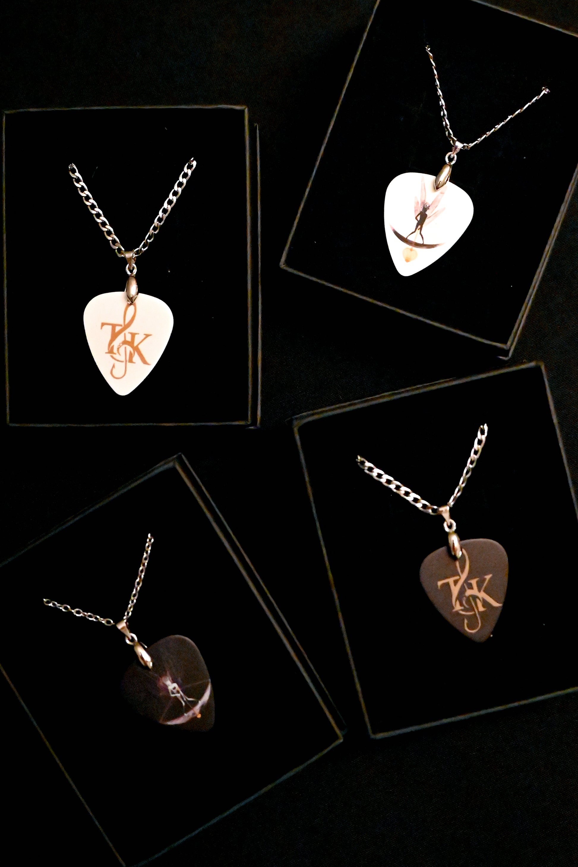 Necklaces with heart-shaped plectrum pendants on a black background