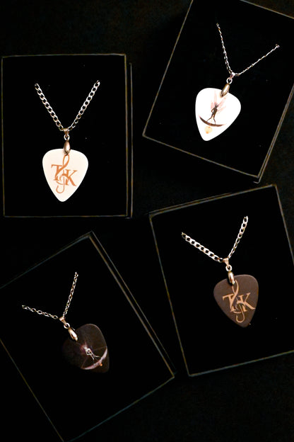 Necklaces with heart-shaped plectrum pendants on a black background